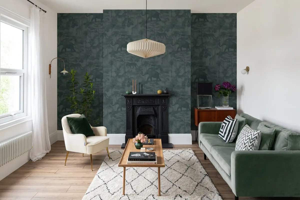 Deep green patterned wallpaper in a sitting room